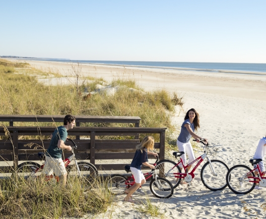 family going to the beach on biked