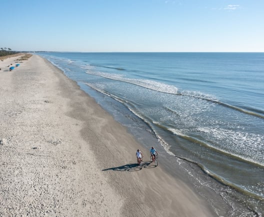 couple biking on the beach