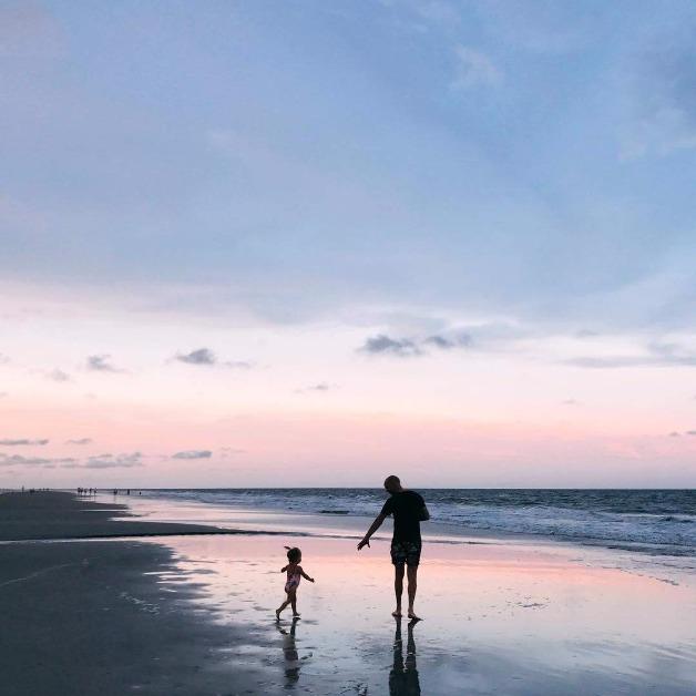 father and daughter on beach