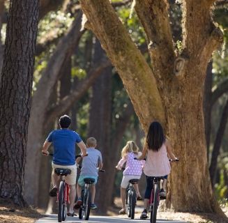 a family biking through trees