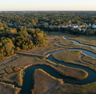 a winding marsh with a dock