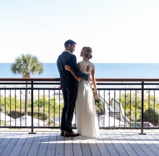 couple standing on an outdoor balcony