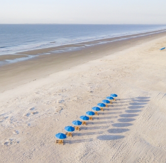 aerial shot of beach with umbrellas
