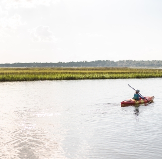 A person kayaking in calm water