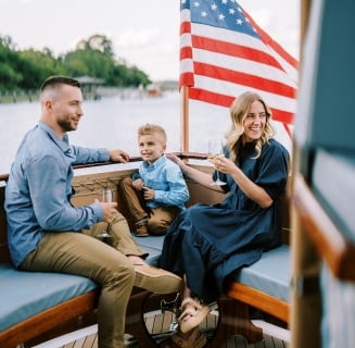 Family on boat with American Flag