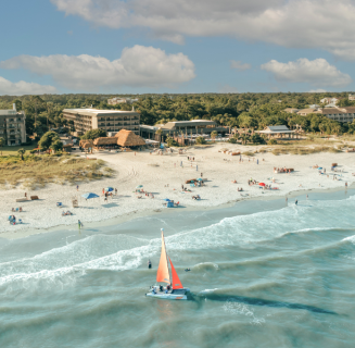 Coastal Savings - BHHHI Resort And Beach Aerial With Sailboat