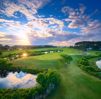 aerial of Palmetto Dunes Jones course with sun peeking through the clouds