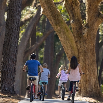 a family biking through trees