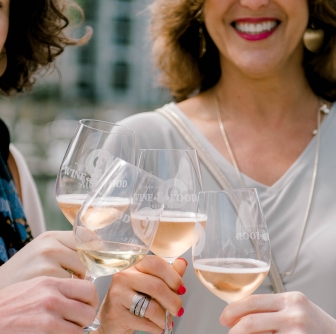 women holding wine glass