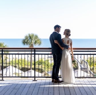 couple standing on an outdoor balcony