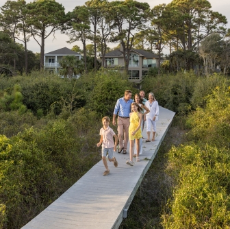 family walking on a boardwalk