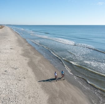 couple biking on the beach