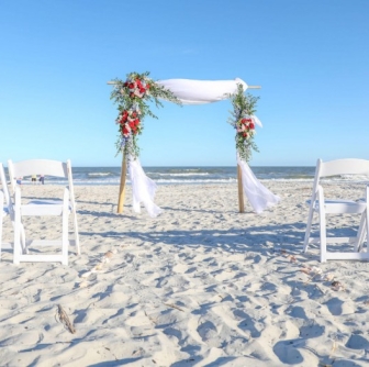 decorated wedding arch set up for wedding ceremony on beach