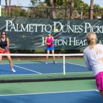 three women playing pickleball at Palmetto Dunes Tennis and Pickleball center