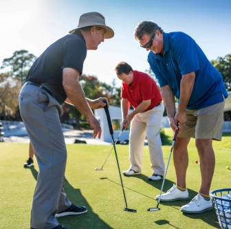 Golf instructor at Palmetto Dunes Golf Academy teaching proper form to two students