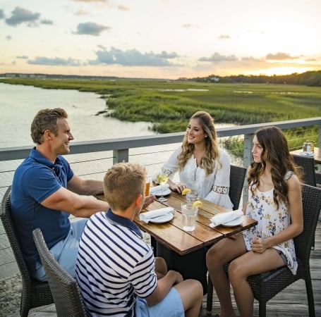 familing of four dining outside