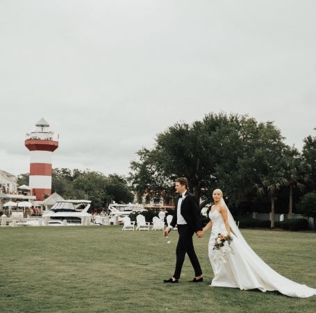 couple walking on a golf course after getting married