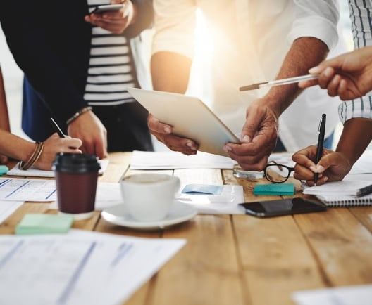 up close photo of people collaborating around a table
