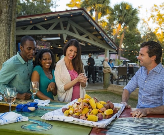 group of people around a table with a lowcountry boil