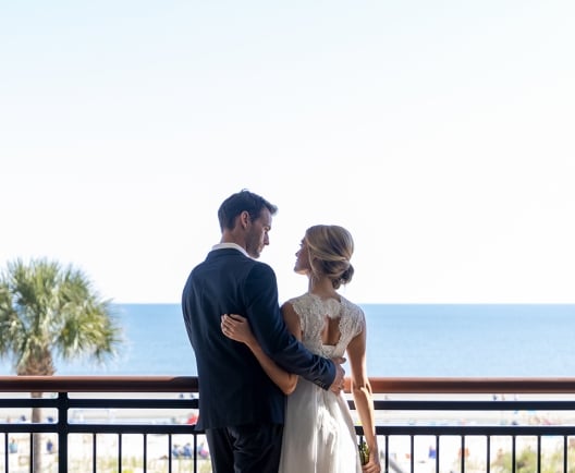 couple standing on an outdoor balcony