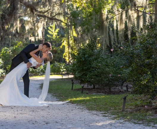 couple embracing among spanish moss covered trees
