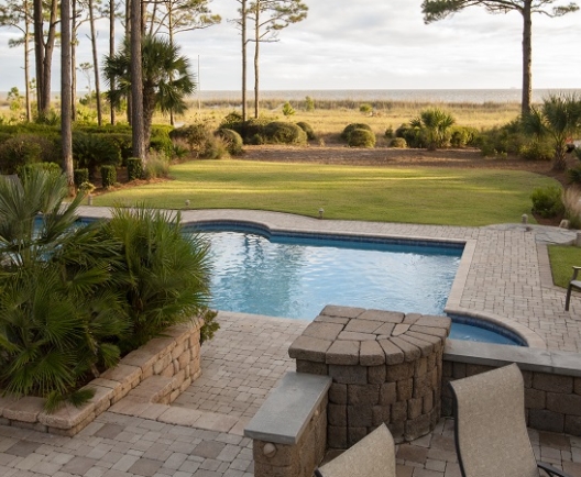 vacation home back yard with in ground pool and pathway leading to the beach