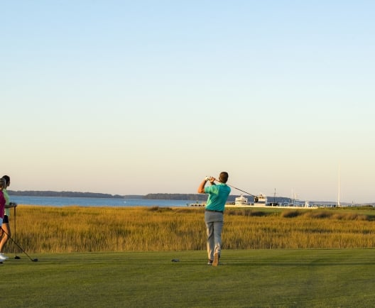 three people golfing
