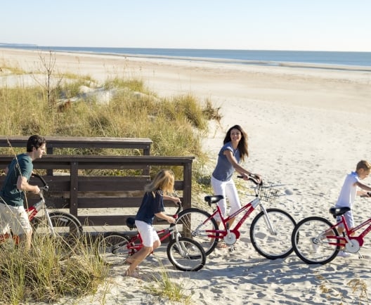 family going to the beach on biked