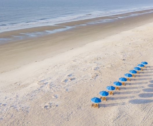 aerial shot of beach with umbrellas