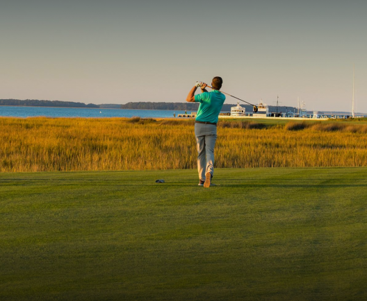 man teeing off at a golf course
