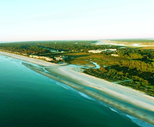 An aerial view of a sandy beach and water