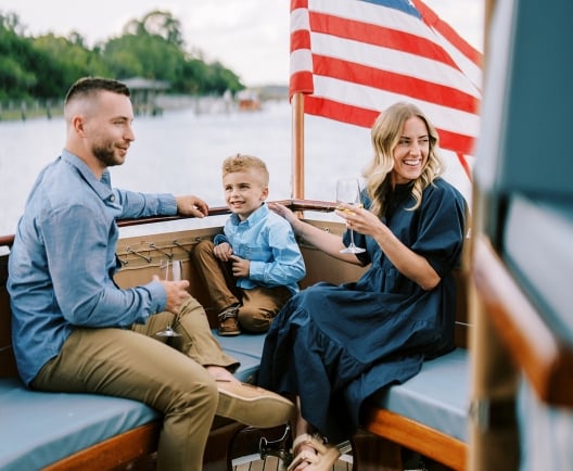 Family on boat with American Flag