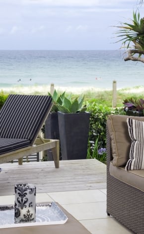 patio looking out at the beach with patio furniture