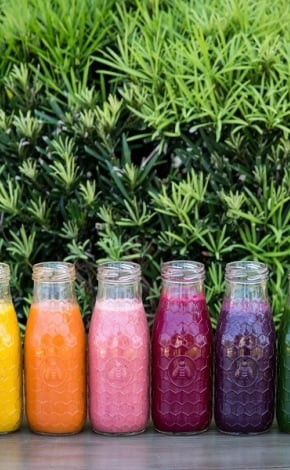 Line up of colourful smoothies and juices