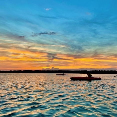 boats in front of a colourful sunset