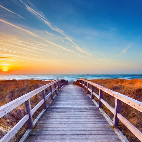 boardwalk leading to the beach at sunset