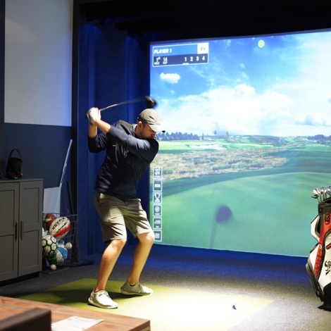 person playing at a golf simulator