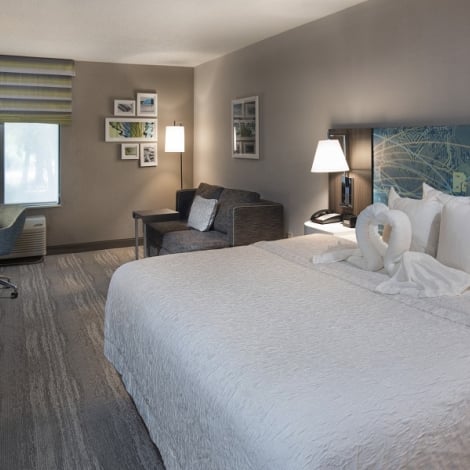 hotel room with large bed and white sheets