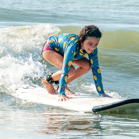 a child on a surboard on the water