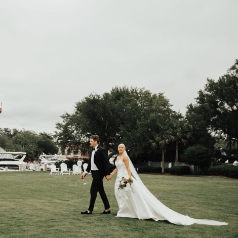 couple walking on a golf course after getting married