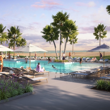 People around a pool with umbrellas and beach in background 