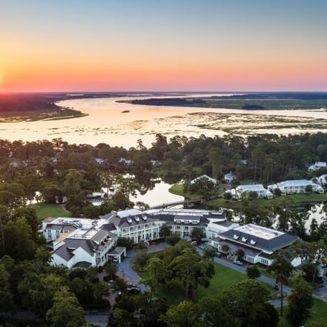 sunset with view of hotel and the water 