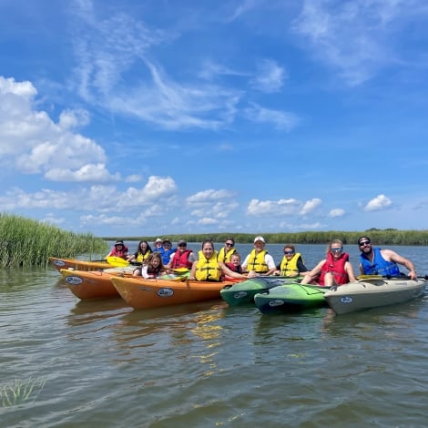 kayakers lined up in the water 