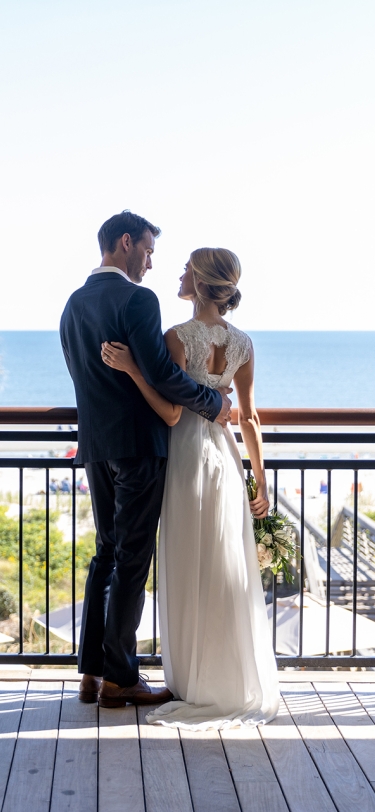 couple standing on an outdoor balcony