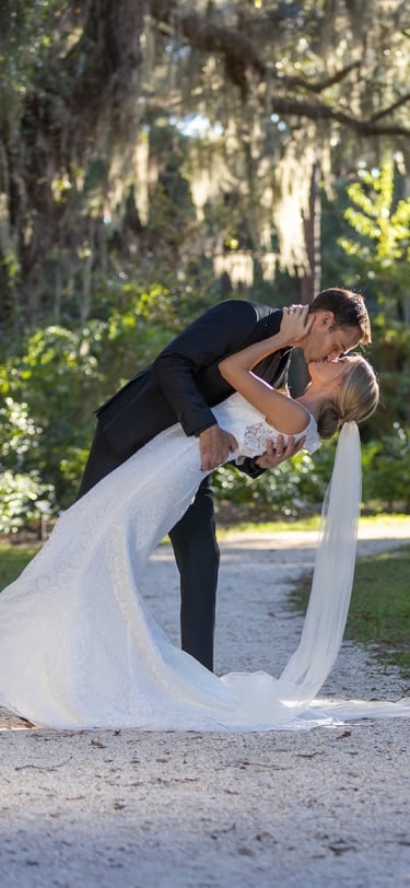 couple embracing among spanish moss covered trees