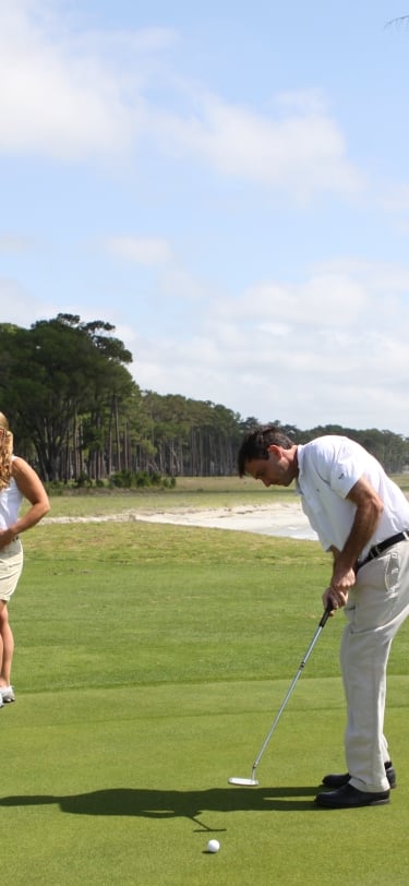 Three people playing golf