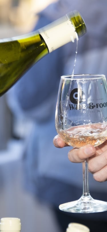 bottle of wine being poured into a glass