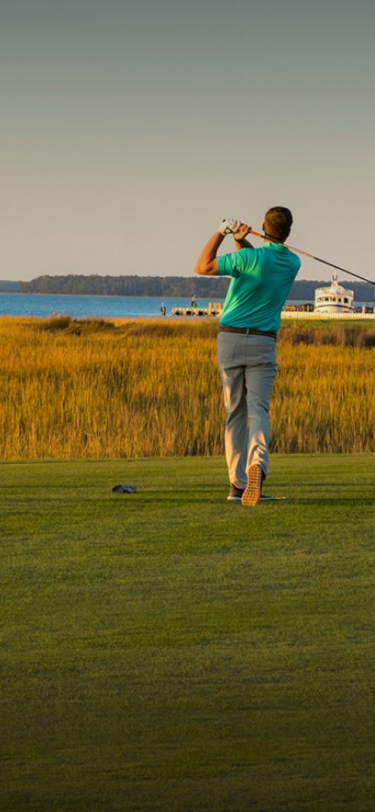 man teeing off at a golf course