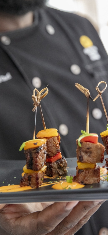 chef holding steak bites on a platter