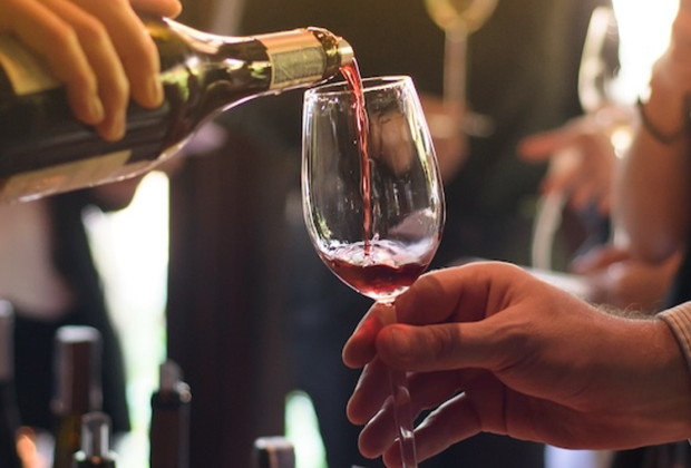 Wine being poured into a held glass